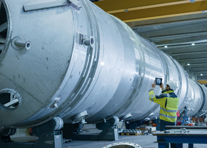 man examinating large turbine
